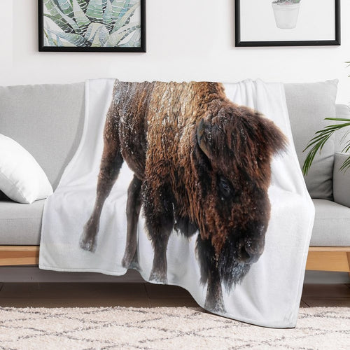 An American Bison Moves Through A Winter Snowstorm Versatility Throw Blanket